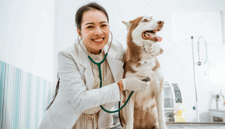 This is a veterinarian posing for a picture with a husky.