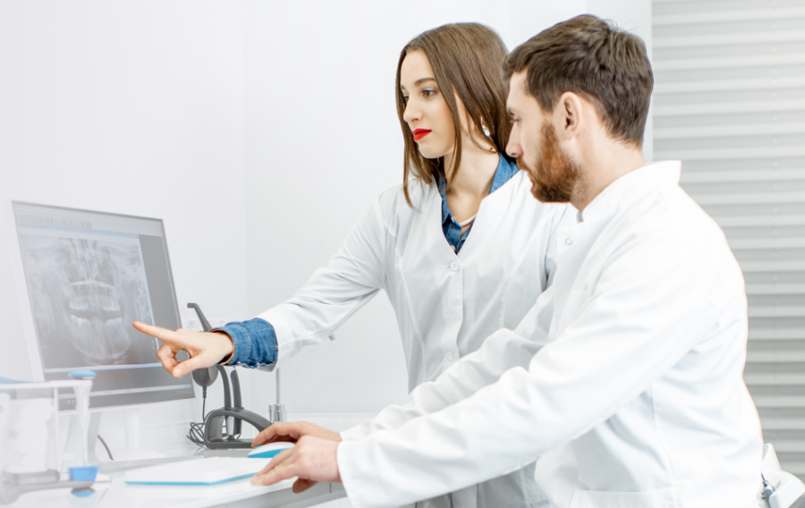 Two dental professionals looking at an x-ray