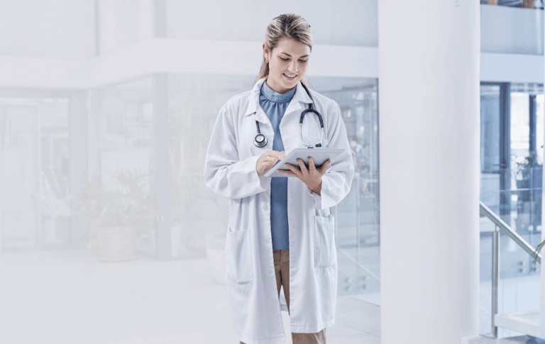 A doctor looking at a tablet.