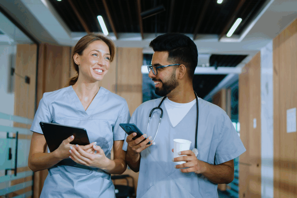 A doctor and a student doctor walking and talking in the hospital hallway