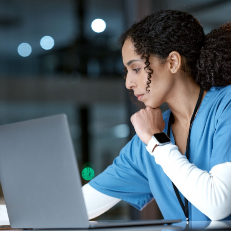 A doctor working on a computer.
