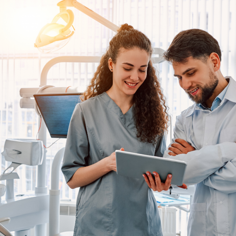 Two dentists standing in an office