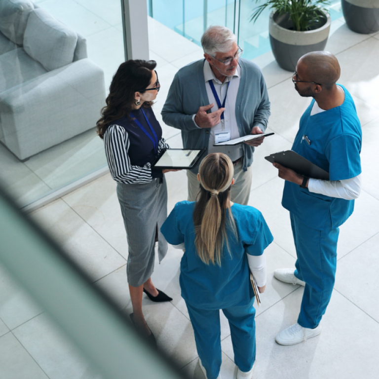 Doctors and medical professionals speak in a lobby