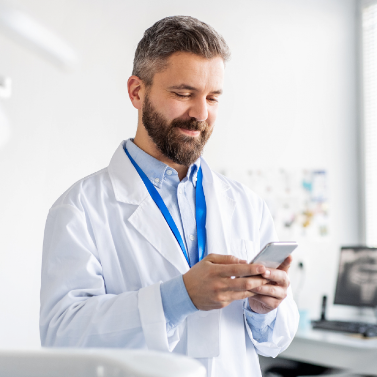 A dentist looking at his phone.