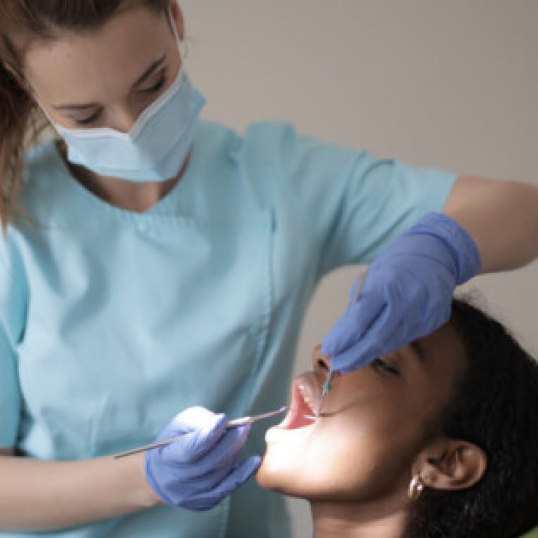 This is a picture of a dentist examining a patient's teeth.